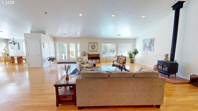 94342 Gauntlett St, Gold Beach, OR 97444 - living room with a wood stove, light wood-style flooring, recessed lighting, and a chandelier