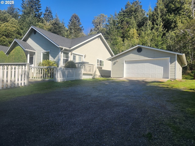 94342 Gauntlett St, Gold Beach, OR 97444 - view of property exterior with an outbuilding, a garage, and roof with shingles