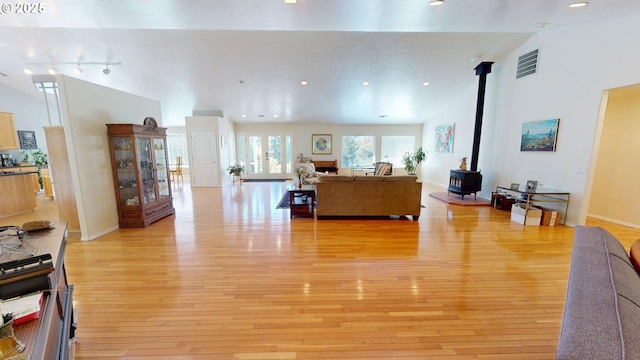 94342 Gauntlett St, Gold Beach, OR 97444 - living room with a wood stove, light wood-style flooring, recessed lighting, and lofted ceiling