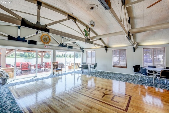 50990 Dike Rd Unit B3, Scappoose, OR 97056 - living area with wood finished floors, beamed ceiling, a ceiling fan, and high vaulted ceiling