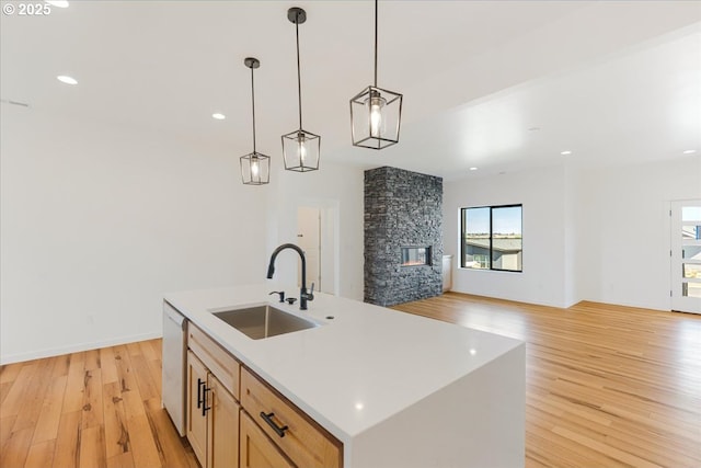 1081 SE Balsamroot Ln, Madras, OR 97741 - kitchen featuring dishwasher, light wood finished floors, decorative light fixtures, open floor plan, and light countertops