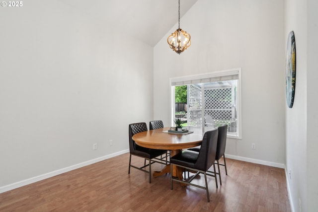 23295 SW Cascade Pl, Sherwood, OR 97140 - dining room featuring high vaulted ceiling, a chandelier, wood finished floors, and baseboards