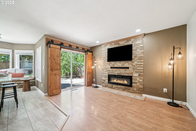 23295 SW Cascade Pl, Sherwood, OR 97140 - living area with baseboards, a fireplace, light wood-style flooring, and recessed lighting