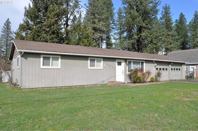 ranch-style home featuring a garage, aphalt driveway, and a front yard