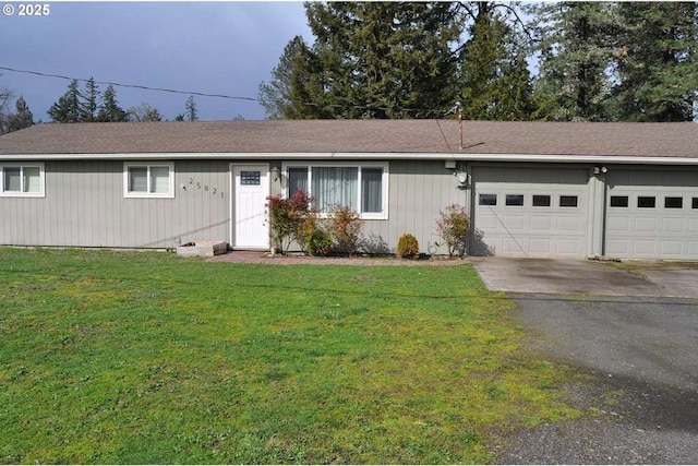 ranch-style house featuring aphalt driveway, a front yard, and an attached garage