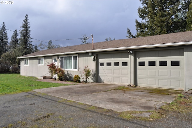 ranch-style home featuring an attached garage, driveway, and a front lawn