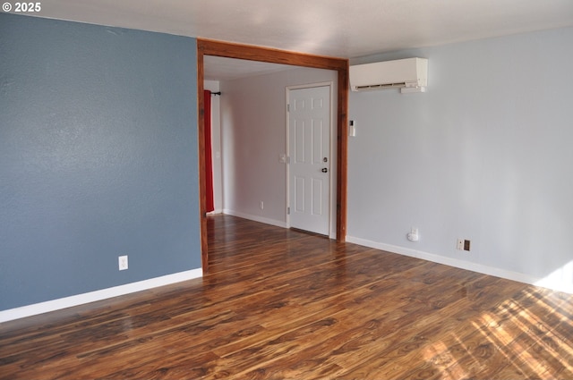 25821 Jeans Rd, Veneta, OR 97487 - spare room featuring a wall unit AC, wood finished floors, and baseboards