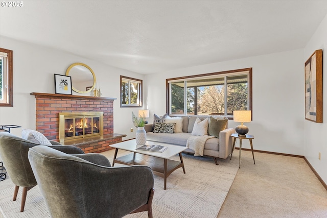 carpeted living area featuring a brick fireplace and baseboards