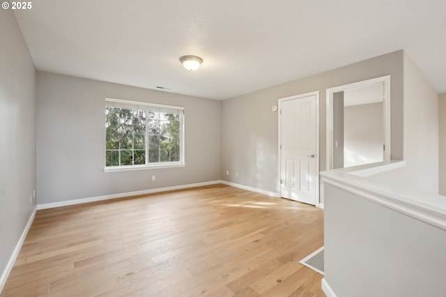 unfurnished room featuring light wood-type flooring