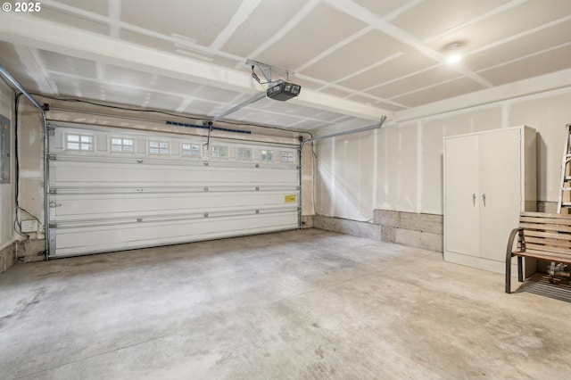 garage featuring a garage door opener and electric panel