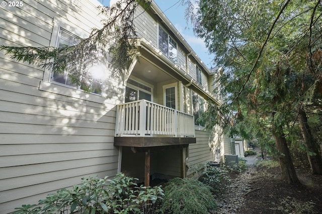 view of home's exterior with a balcony and central air condition unit