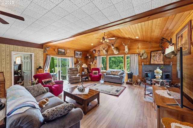 96863 Sitkum Ln, Myrtle Point, OR 97458 - living room with a ceiling fan, healthy amount of natural light, wood-type flooring, wooden walls, and wallpapered walls