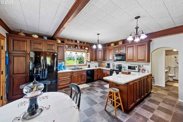 96863 Sitkum Ln, Myrtle Point, OR 97458 - kitchen featuring black appliances, arched walkways, a peninsula, light countertops, and hanging light fixtures