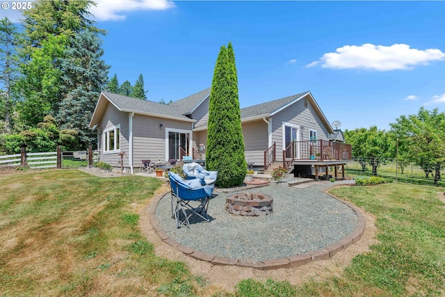 96863 Sitkum Ln, Myrtle Point, OR 97458 - rear view of property featuring an outdoor fire pit, a wooden deck, a fenced backyard, and a patio