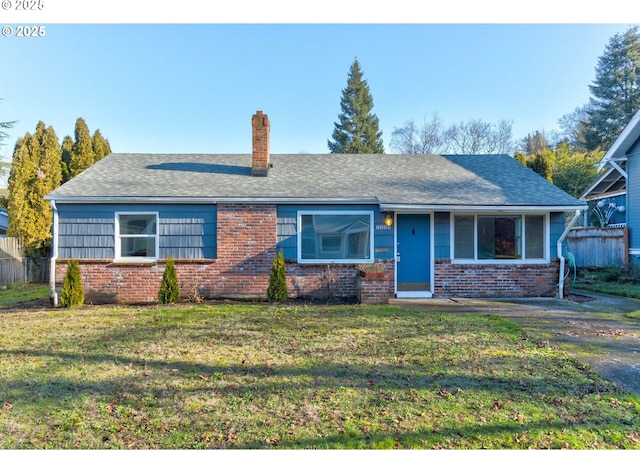 single story home with brick siding, roof with shingles, a chimney, fence, and a front lawn