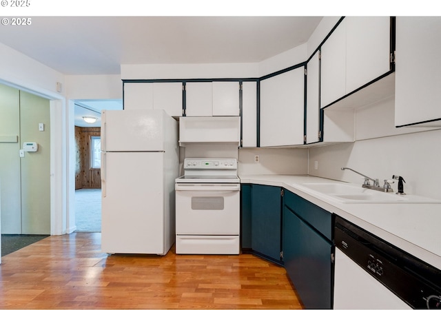 kitchen featuring white appliances, a sink, white cabinetry, light wood-style floors, and light countertops