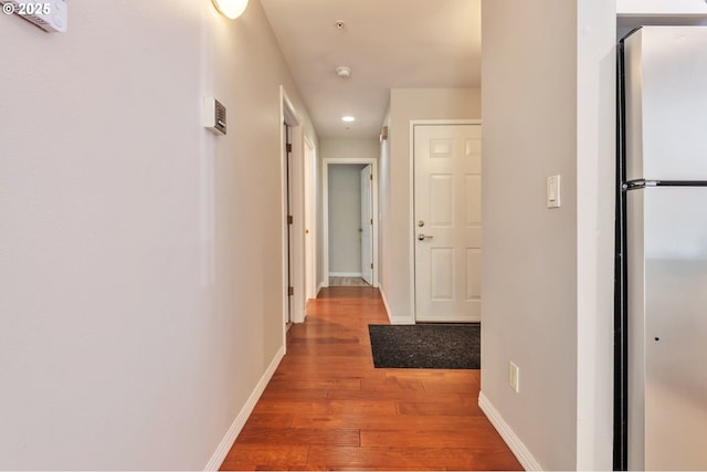 2709 SW 2nd Ave Unit 201, Portland, OR 97201 - empty room with light wood-type flooring, rail lighting, baseboards, and baseboard heating