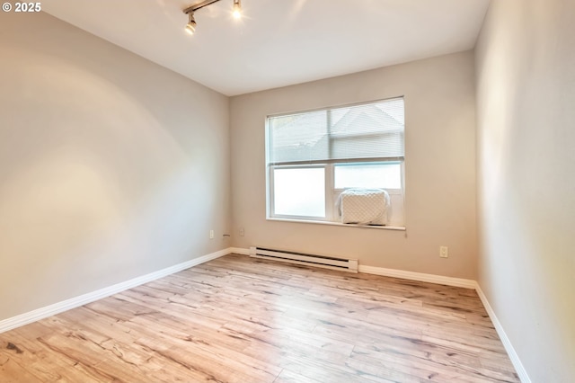 2709 SW 2nd Ave Unit 201, Portland, OR 97201 - unfurnished bedroom featuring light wood-style floors, rail lighting, and baseboards