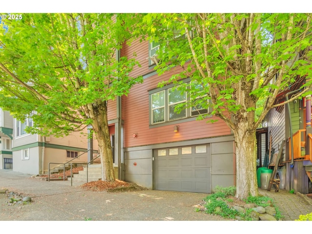 townhome / multi-family property with a garage and driveway