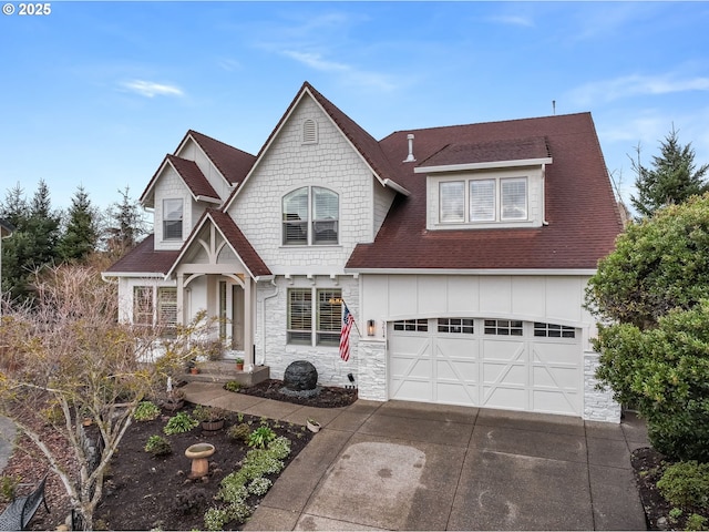 view of front facade with a shingled roof, concrete driveway, stone siding, an attached garage, and board and batten siding