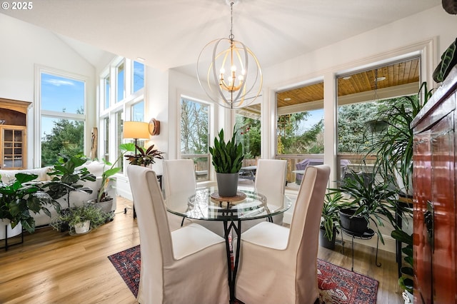 sunroom featuring a chandelier and vaulted ceiling