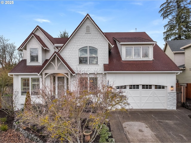 view of front of home featuring a garage, concrete driveway, roof with shingles, and board and batten siding