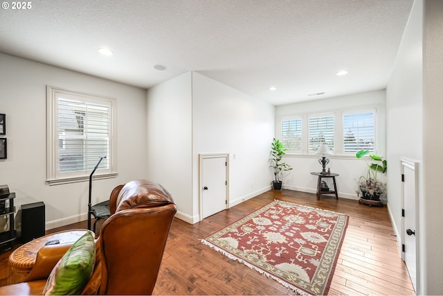 office with a textured ceiling, recessed lighting, wood finished floors, and baseboards