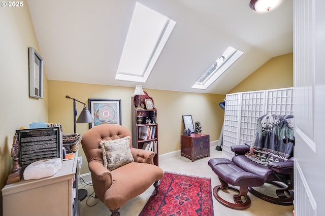 living area with lofted ceiling with skylight, carpet, and baseboards