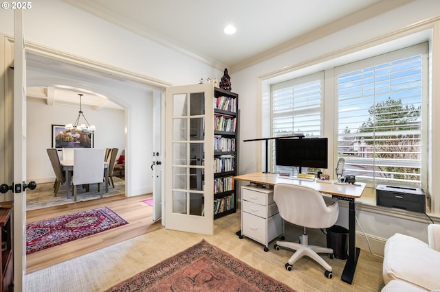 office area with a healthy amount of sunlight, arched walkways, and french doors