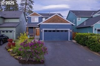craftsman-style home with driveway and an attached garage