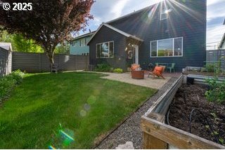 rear view of property with a vegetable garden and a patio area