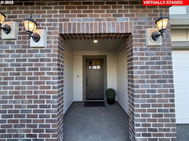 entrance to property featuring brick siding