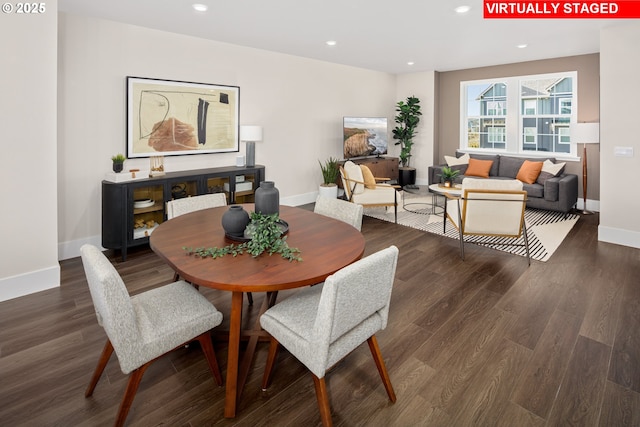 dining area with baseboards, wood finished floors, and recessed lighting