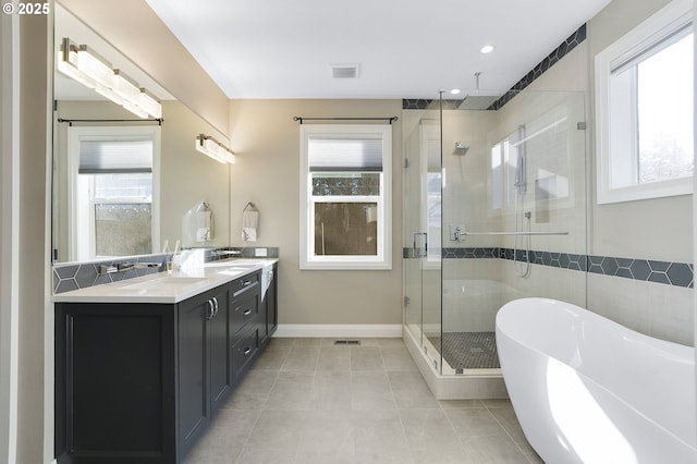 bathroom with tile patterned floors, separate shower and tub, and vanity