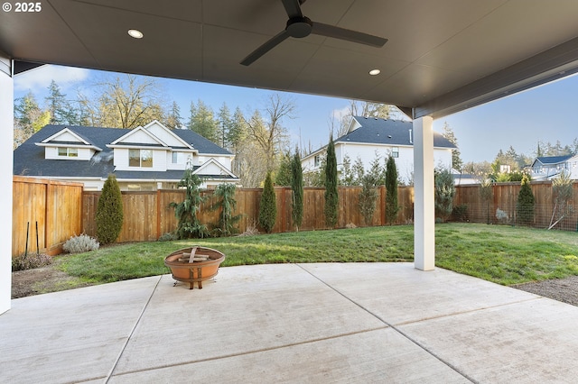 view of patio with ceiling fan and an outdoor fire pit