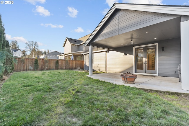 view of yard with a patio area, ceiling fan, an outdoor fire pit, and french doors