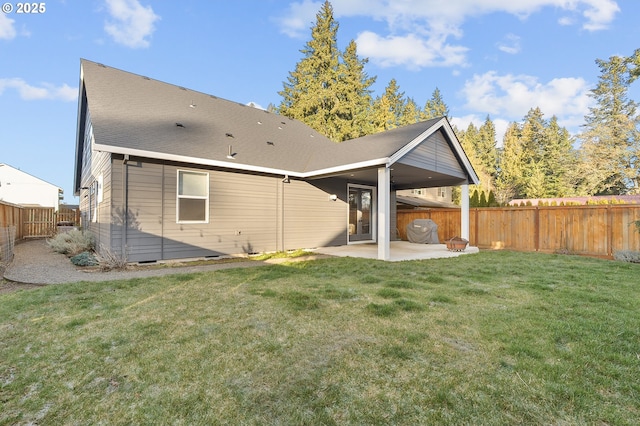 back of house featuring a yard and a patio