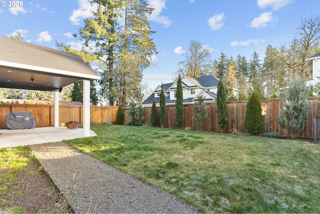 view of yard featuring ceiling fan and a patio