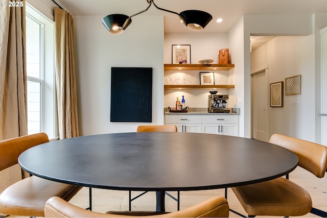 dining area with a bar and healthy amount of natural light