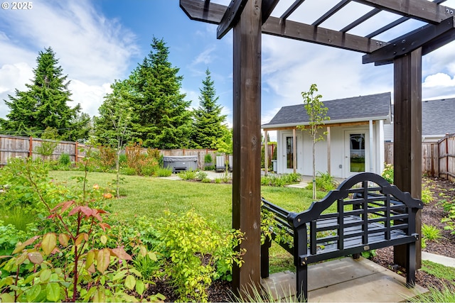 view of yard featuring a hot tub, a pergola, and an outbuilding