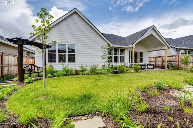 rear view of property with a patio and a shingled roof