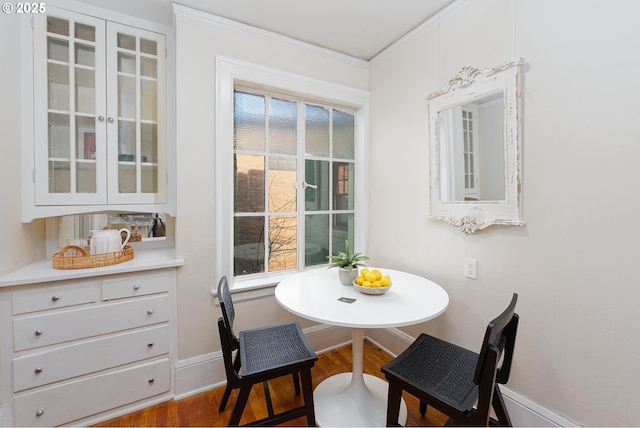 dining room with ornamental molding and hardwood / wood-style floors