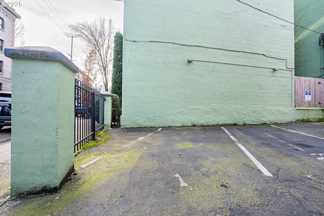 uncovered parking lot featuring fence