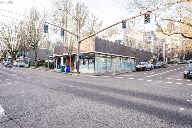 view of street featuring traffic lights, curbs, and sidewalks