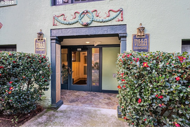 entrance to property with stucco siding