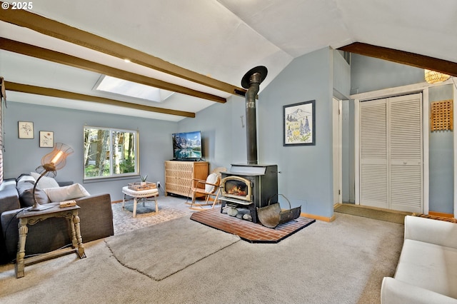625 Wilson Rd, Mosier, OR 97040 - living room with lofted ceiling, a wood stove, carpet flooring, and baseboards