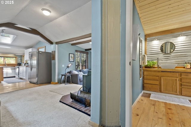 625 Wilson Rd, Mosier, OR 97040 - hall featuring lofted ceiling, baseboards, light wood finished floors, a skylight, and a sink