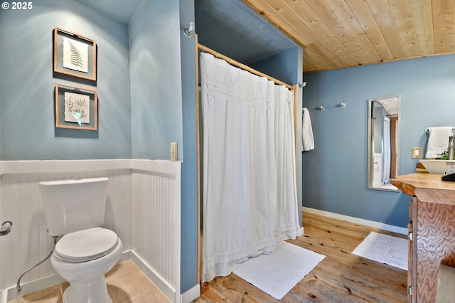 625 Wilson Rd, Mosier, OR 97040 - bathroom featuring toilet, wood finished floors, a shower with curtain, baseboards, and wood ceiling