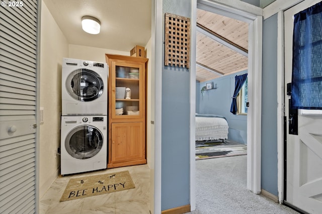 625 Wilson Rd, Mosier, OR 97040 - clothes washing area with stacked washing machine and dryer, baseboards, and carpet flooring