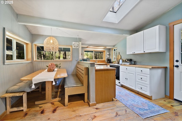 625 Wilson Rd, Mosier, OR 97040 - kitchen with electric range, light wood-type flooring, white cabinets, and a skylight
